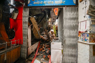 NEW DELHI, INDIA: JUNE 14, 2024 - Firefighters seen during cooling off operations on second day after a fire broke out inside old Katra Marwadi Market of Chandni Chowk at Nai Sadak on June 14 2024 in New Delhi, India.  clipart