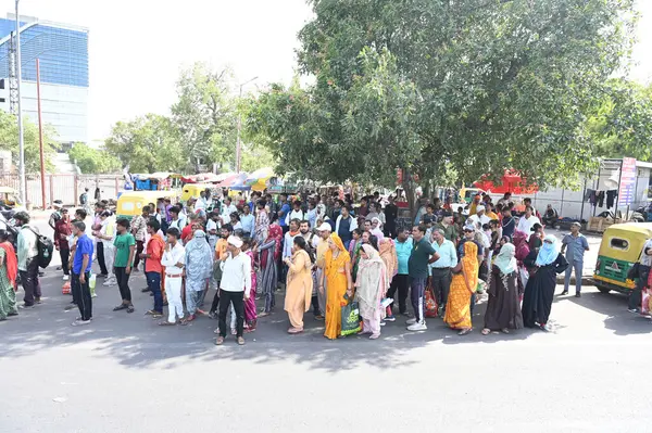 stock image NEW DELHI INDIA JUNE 13 2024   DTC Passengers standing under a tree shadow on a hot summer afternoon at Jawaharlal Nehru Marg  Near Ajmeri Gate side  New Delhi Railway Station on June 13 2024 in New Delhi India.  Photo by Sonu Mehta/Hindustan Times 