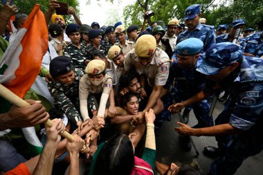 NEW DELHI INDIA MAY 28 2023 Wrestlers Sakshi Malik Vinesh Phogat Bajrang Punia along with supporters lead the protest march from Jantar Mantar towards New Parliament for the Mahila Panchayat climbed the barricades and later detained by the Delhi Poli clipart