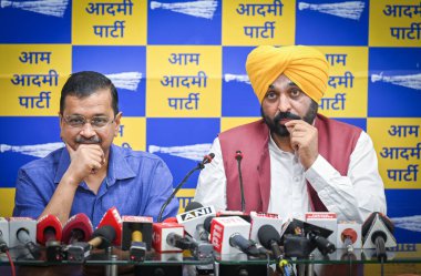 NEW DELHI INDIA MAY 13 2023 AAP Convenor and Delhi Chief Minister Arvind Kejriwal held a joint press conference with Punjab Chief Minister Bhagwant Singh Mann after the Jalandhar by election result at the Aam Aadmi Party office on May 13 2023 in New  clipart