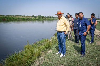 NEW DELHI INDIA MAY 7 2023 Vinai Kumar Saxena Lieutenant Governor of Delhi inspects the Chinar Island during his visit to Mini Islands that are being rejuvenated by the authorities in Yamuna River near Yamuna Bazaar on May 7 2023 in New Delhi India P clipart