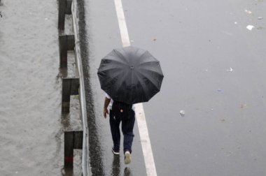 GURUGRAM INDIA MAY 27 2023 People cross a waterlogged stretch for going to their workplace at Narsinghpur village near foot over bridge on May 27 2023 in Gurugram India Photo by Parveen Kumar Hindustan Times  clipart