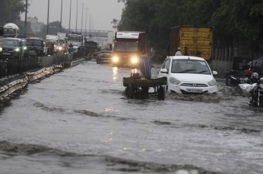 GURUGRAM INDIA MAY 3 2023 Vehicles wade through a waterlogged stretch between Khandsa to Narsighpur village in rain on the NH 48 service road near Shani Mandir on May 3 2023 in Gurugram India Photo by Parveen Kumar Hindustan Times  clipart