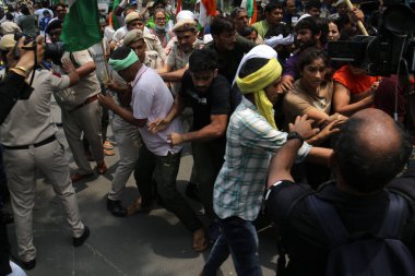 NEW DELHI INDIA MAY 28 2023 Wrestlers Sakshi Malik Vinesh Phogat Bajrang Punia along with supporters lead the protest march from Jantar Mantar towards New Parliament for the Mahila Panchayat climbed the barricades and later detained by the Delhi Poli clipart