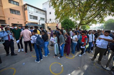 NEW DELHI INDIA MAY 21 2023 Students standing in queues to appear for the first slot of Common University Entrance Test for undergraduate admissions CUET UG at an examination center at Mohan Estate on May 21 2023 in New Delhi India The CUET UG 2023 e clipart