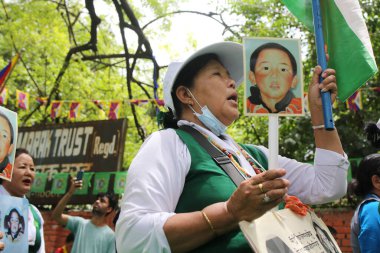 NEW DELHI INDIA MAY 17 2023 Tibetan Women association hold placards during their protest against the Chinese government on the 28 year of the enforced disappearance of the 11th Panchen Lama Tenzin Gendun Yeshi Thinley Phuntsok at Jantar Mantar on May clipart