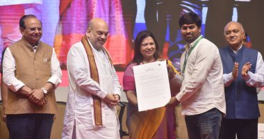 NEW DELHI INDIA MAY 3 2023 Union Home Minister Amit Shah Delhi LG Vinai Kumar Saxena and MOS for External Affairs Meenakshi Lekhi during the present the appointment letters to a NDMC staff at Talkatora Indoor Stadium on May 3 2023 in New Delhi India  clipart