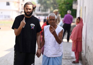 LUCKNOW INDIA MAY 4 2023 A youth accompanied with his Grandfather show inked fingers exiting the booth after casting their vote during the local bodies election at Chinhat polling booth on May 4 2023 in Lucknow India Photo by Deepak Gupta Hindustan T clipart