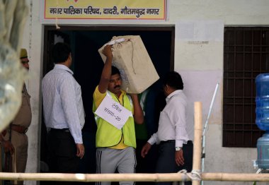 GREATER NOIDA INDIA MAY 13 2023 Election Commission staff carrying the ballot papers for the local body elections at Mihir Bhoj PG College in Dadri on May 13 2023 in Greater Noida India The Bhartiya Janata Party swept the Uttar Pradesh local body pol clipart