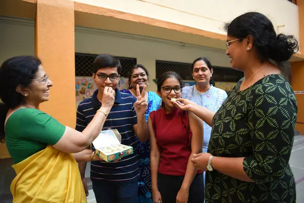 stock image NAVI MUMBAI INDIA MAY 14 2023 Teachers and parents of North Point School celebrate ISC 12th and 10th exam results with toppers Sudeep Pradyot Bera who scored 99% and Stuti Saurabh Shah 99 4% respectively at Koparkhairane on May 14 2023 in Navi Mumbai