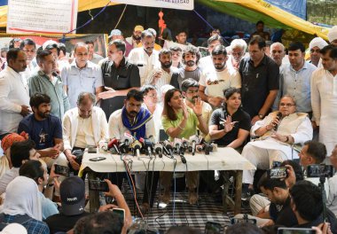 NEW DELHI INDIA MAY 15 2023 Protesting Wrestlers Vinesh Phogat Bajrang Punia Shakhi Malik share dias with Former Union Minister Birender Singh Former Governor of Jammu and Kashmir Satya Pal Malik Bhim Army President Chander Shekhar Ravan and BKU lead clipart