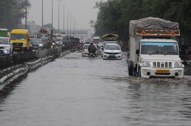 GURUGRAM INDIA MAY 3 2023 Vehicles wade through a waterlogged stretch between Khandsa to Narsighpur village in rain on the NH 48 service road near Shani Mandir on May 3 2023 in Gurugram India Photo by Parveen Kumar Hindustan Times  clipart