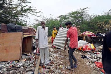 NEW DELHI INDIA MAY 2 2023 Locals seen taking out their valuables from the demolished structures as ASI along with the district administration carries out demolishing drive of illegal constructions near Tughlaqabad Fort on May 2 2023 in New Delhi Ind clipart