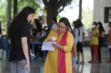 GURUGRAM INDIA MAY 7 2023 National Eligibility cum Entrance Test NEET candidates in a queue before entering the examination centre in Drona Public School at Ravi Nagar Basai Road near Government college sector 9 on May 7 2023 in Gurugram India This y clipart