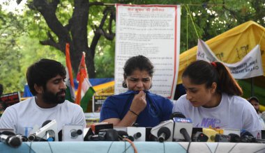 NEW DELHI INDIA MAY 26 2023 Wrestlers Bajrang Punia Sakshi Malik and Vinesh Phogat addressing a press conference during the ongoing their protest against the Wrestling Federation of India president Brij Bhushan Sharan Singh at Jantar Mantar on May 26 clipart