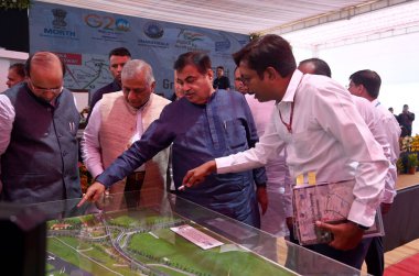 GURUGRAM INDIA MAY 18 2023 Nitin Gadkari Union minister for road transport and highways and VK Singh Union Minister of State for Civil Aviation and Road Transport and Highways seeing the layout plan of Dwarka expressway at National Highway 48 cloverl clipart