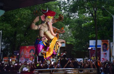 MUMBAI, INDIA - AUGUST 24: Devotees carry an Idol of lord Ganesha through the street, ahead of Ganesh Chaturthi Festival, on August 24, 2024 in Mumbai, India. (Photo by Bhushan Koyande/Hindustan Times ) clipart