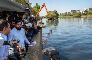 MUMBAI INDIA MAY 18 2023 Maharashtra Chief Minister Eknath Shinde along with Brihanmumbai Municipal Corporation Commissioner and Administrator Iqbal Singh Chahal inspecting the desilting works of Mithi River at BKC on May 18 2023 in Mumbai India Phot clipart