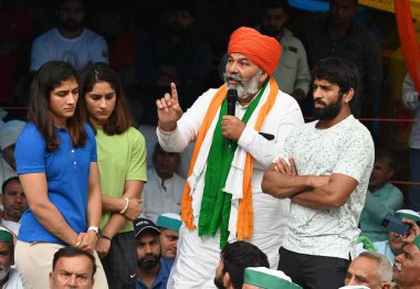 NEW DELHI INDIA MAY 2 2023 Rakesh Tikait National spokesperson of the Bharatiya Kisan Union BKU with Wrestlers Sangita Phogat Vinesh Phogat and Bajrang Punia addressing the gathering as he came to support protesting wrestlers at Jantar Mantar on May  clipart