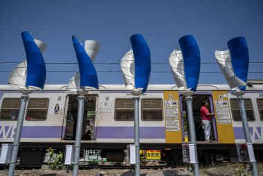 MUMBAI INDIA MAY 20 2023 Western Railway WR for the first time is trying to generate electricity through wind energy and has installed mini windmills next to Khar and Naigaon railway stations on May 20 2023 in Mumbai India Photo by Satish Bate Hindus clipart