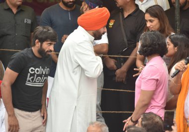 NEW DELHI INDIA MAY 1 2023 Congress Leader Navjot Singh Sidhu meet and talking with Wrestlers Vinesh Phogat Sakshi Malik and others during the Ninth day dharna their protest against the Wrestling Federation of India president Brij Bhushan Saran at Ja clipart