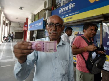 YENİ DELHI INDIA 23 MAYIS 2023 Bir adam CP 'de 23 Mayıs 2023 tarihinde Hint bankasının dışında değiştirilmeden önce 2000 Rupi tutuyor Hindistan rezerv bankası piyasadan 2000 Rupi çekildiğini ve varolduğunu duyurdu