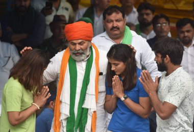 NEW DELHI INDIA MAY 2 2023 Bharatiya Kisan Union BKU leader Rakesh Tikait with wrestlers Bajrang Punia Vinesh Phogat Sangita Phogat and others during the protest dharna against the Wrestling Federation of India president Brij Bhushan Saran at Jantar  clipart