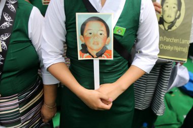 NEW DELHI INDIA MAY 17 2023 Tibetan Women association hold placards during their protest against the Chinese government on the 28 year of the enforced disappearance of the 11th Panchen Lama Tenzin Gendun Yeshi Thinley Phuntsok at Jantar Mantar on May clipart