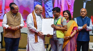 NEW DELHI INDIA MAY 3 2023 Union Home Minister Amit Shah Delhi LG Vinai Kumar Saxena and MOS for External Affairs Meenakshi Lekhi during the present the appointment letters to a NDMC staff at Talkatora Indoor Stadium on May 3 2023 in New Delhi India  clipart