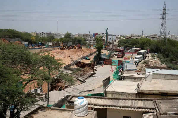 stock image NEW DELHI INDIA MAY 20 2023 A portion of road caved during the excavation work near under construction Maidan Garhi metro station in South Delhi road has sunk around 50 feet deep on May 20 2023 in New Delhi India No injuries have been reported in the