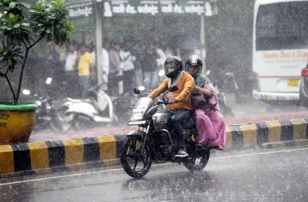 stock image GHAZIABAD, INDIA - AUGUST 23: Due to heavy rain near Hapur road near district magistrate office, two wheelers were seen getting drenched in the rain and some women were seen walking in the rain, on August 23, 2024 in Ghaziabad, India. (Photo by Sakib