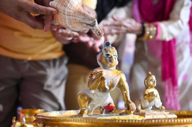 GURUGRAM INDIA AUGUST 26 2024 Devotees performing Jal Abhishek of Lord Krishna during the Krishna Janmashtami festival at ISKCON temple in Sector 45 near Delhi Public School on August 26 2024 in Gurugram India Photo by Parveen Kumar Hindustan Times  clipart