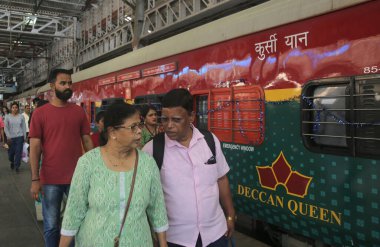 MUMBAI INDIA JUNE 1 2023 Commuters celebrate the birthday of Deccan Queen the Indian Railways first deluxe train as it completed 93 glorious years of operations between Pune and Mumbai at CSMT Railway Station on June 1 2023 in Mumbai India Photo by B clipart