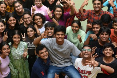 NAVI MUMBAI INDIA JUNE 2 2023 Students of Fr Agnel Multipurpose School and Junior College celebrate success with topper Nair Avneesh Amar who secured 984% after the SSC Board Exam results were declared at Vashi on June 2 2023 in Navi Mumbai India Thi clipart