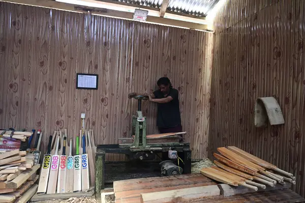 stock image SRINAGAR INDIA JUNE 12 2023 A laborer works in a GR8 cricket bat manufacturing unit in Sangam some 38 kilometers south of Srinagar on June 12 2023 in Srinagar India GR8 bat manufacturers have received an order for bats to be used during the 2023 One 