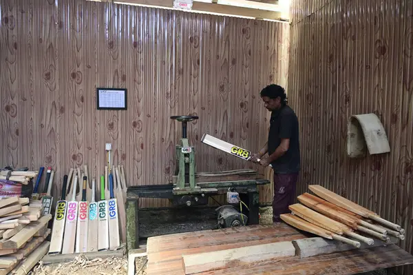 stock image SRINAGAR INDIA JUNE 12 2023 A laborer works in a GR8 cricket bat manufacturing unit in Sangam some 38 kilometers south of Srinagar on June 12 2023 in Srinagar India GR8 bat manufacturers have received an order for bats to be used during the 2023 One 