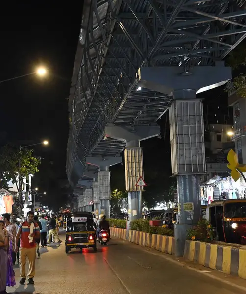 stock image MUMBAI INDIA JUNE 10 2023 Streetlights under the skywalk and inside the skywalk are non functional while some pillars of the skywalk are seen illuminated with colorful lightings as part of the BMC beautification project on SV Road at Borivali West on