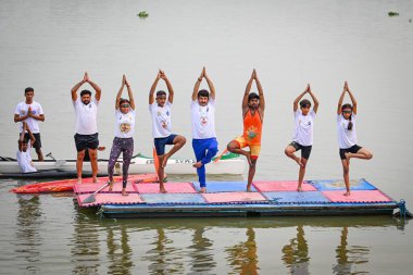 NEW DELHI INDIA JUNE 21 2023 Manoj Tiwari Member of Parliament performs Yoga along with the students of Water Sports Club in Sonia Vihar over Yamuna River on the occasion of International Yoga Day on June 21 2023 in New Delhi India Photo by Sanchit K clipart