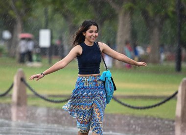 NEW DELHI INDIA JUNE 16 2023 Visitors having fun at Kartavya Path during sudden heavy rain on June 16 2023 in New Delhi India The India Meteorological Department had predicted light rain with gusty winds in Delhi NCR on Thursday According to the weat clipart