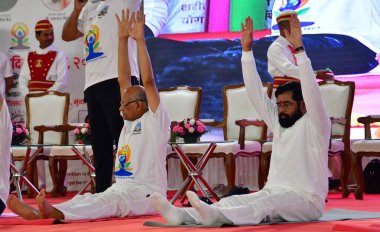 MUMBAI INDIA JUNE 21 2023 Maharashtra Governor Ramesh Bais Maharashtra CM Eknath Shinde Maharashtra DCM Devendra Fadnavis along with Maharashtra Assembly Speaker Rahul Narvekar perform yoga to celebrate International Yoga Day at Vidhan Bhavan on June clipart