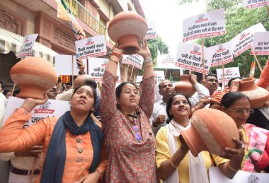 NEW DELHI INDIA JUNE 24 2023 Virendra Sachdeva President of Delhi BJP along with LOA Ramvir Singh Bidhuri and party workers and supporters protest against the Delhi Jal Board over the supply of alleged bad quality of water in the city at Varunalaya C clipart