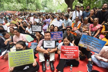 NEW DELHI INDIA JUNE 24 2023 Members of the Kuki tribe and their supporters take part in a tribal solidarity protest against the alleged ethnic cleansing in Manipur state at Jantar Mantar on June 24 2023 in New Delhi India They demanded fair and deci clipart