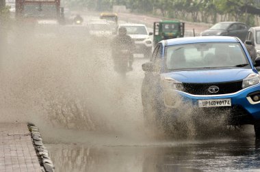 GHAZIABAD INDIA JUNE 25 2023 Vehicles drive through a waterlogged stretch after heavy rains at Lal Kuan Road on June 25 2023 in Ghaziabad India Heavy rainfall accompanied by lightning lashed several parts of the national capital Delhi and its adjoini clipart