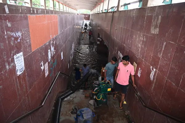 stock image GURUGRAM INDIA JUNE 25 2023 Workers installed a drainage pump to remove water from Subway underpass at National Highway 48 near Anaj Mandi on June 25 2023 in Gurugram India Heavy rainfall accompanied by lightning lashed several parts of the national 