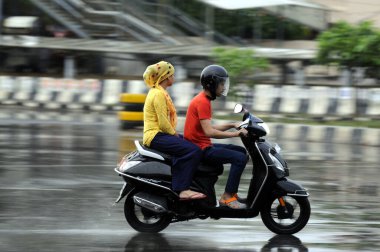 GURUGRAM INDIA JUNE 19 2023 People are going to their workplace amid rain at National Highway 48 near Rajiv chowk on June 19 2023 in Gurugram India The city received 5mm of rainfall during the 24 hour period which ended at 830am on Monday The minimum clipart