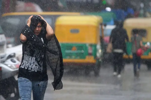 stock image NEW DELHI INDIA JUNE 19 2023 People passing by streets during rain on a afternoon at Jangpura area on June 19 2023 in New Delhi India The city received 5mm of rainfall during the 24 hour period which ended at 830am on Monday The minimum temperature s