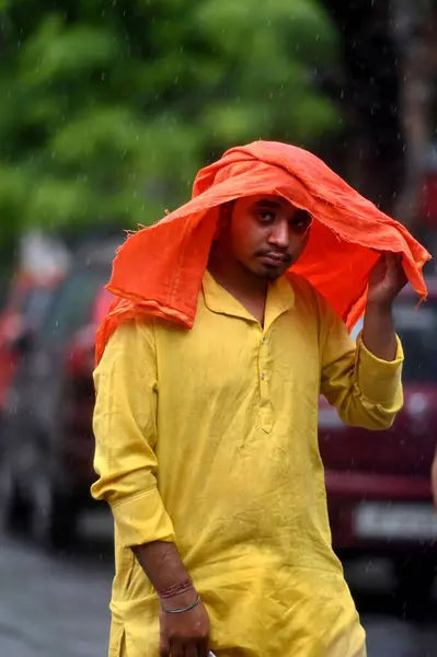 stock image NOIDA INDIA JUNE 19 2023 Commuters out in the light rain on the Sector 12 road on June 19 2023 in Noida India The city received 5mm of rainfall during the 24 hour period which ended at 830am on Monday The minimum temperature settled at 255 degrees Ce