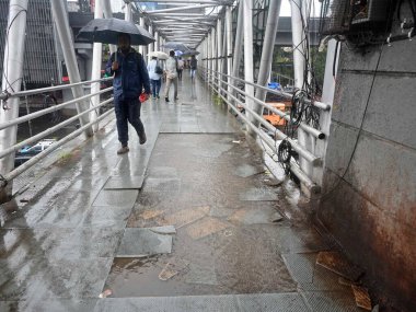 MUMBAI INDIA JUNE 28 2023 Tiles on a Skywalk are broken and rain water is stuck on the skywalk Public won t be able to walk on Western Express Highway at Goregaon on June 28 2023 in Mumbai India Photo by Vijay Bate Hindustan Times  clipart