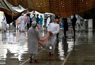 NOIDA INDIA JUNE 29 2023 Muslims devotees wait to offer Eid al Adha prayer at Sector 8 Jama Masjid on a rainy day on June 29 2023 in Noida India Eid ul Adha also known as Bakra Eid Bakrid Eid al Adha Eid Qurban or Qurban Bayarami is Islamic festivals clipart