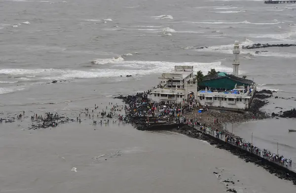 stock image MUMBAI INDIA JUNE 30 2023 A large crowd of Muslim worshipers thronging the pathway leading to iconic Haji Ali Dargah on the second day of Bakri Eid at Mahalaxmi on June 30 2023 in Mumbai India Photo by Bhushan Koyande Hindustan Times 